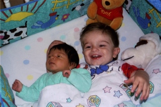 Mikey is happy to lay with baby Anthony - Sep '98